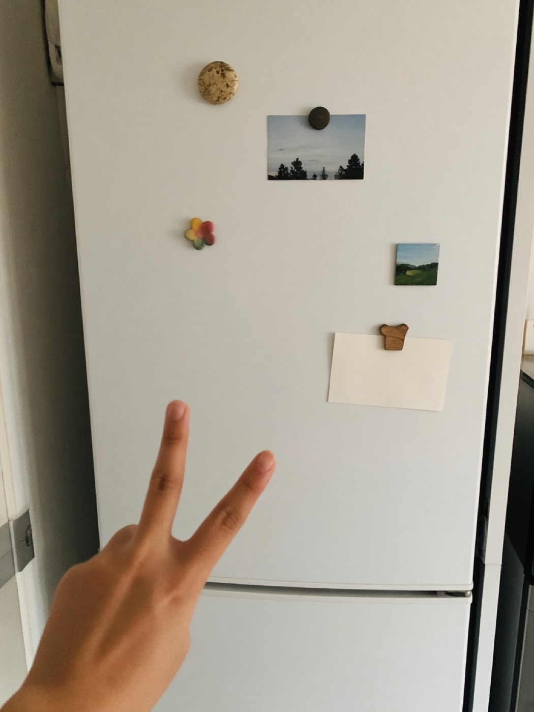A fridge with two fingers held up